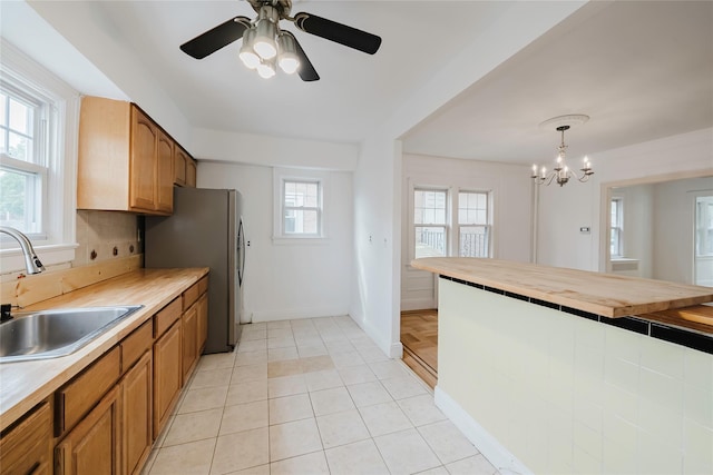 4220 Wickham Ave, Bronx, NY 10466 - kitchen featuring a sink, freestanding refrigerator, wooden counters, and brown cabinetry