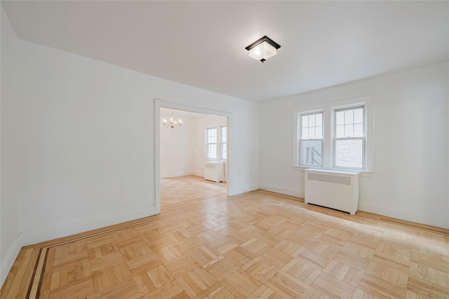 4220 Wickham Ave, Bronx, NY 10466 - unfurnished room with radiator heating unit, baseboards, and an inviting chandelier
