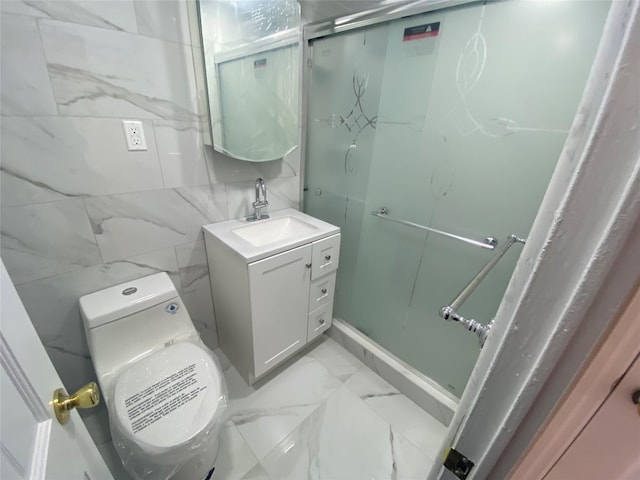 bathroom featuring vanity, marble finish floor, and toilet