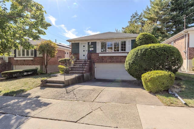 view of front of home with an attached garage, concrete driveway, and brick siding