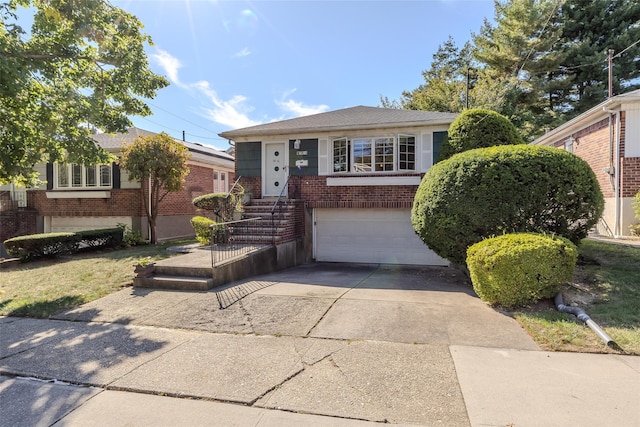 bungalow-style home featuring concrete driveway, brick siding, and a garage