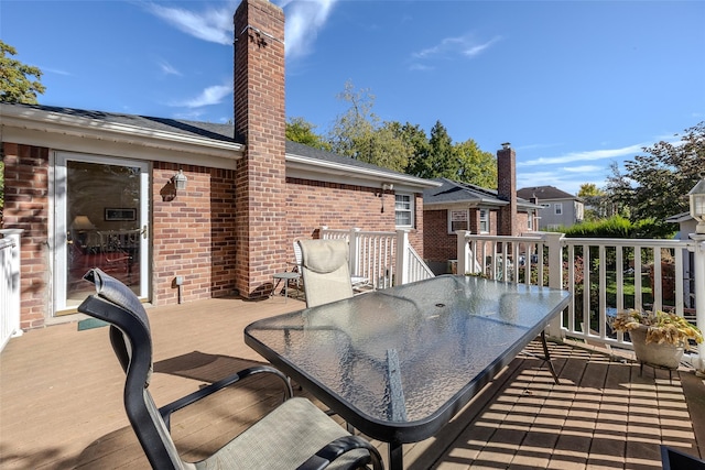 wooden terrace with outdoor dining area