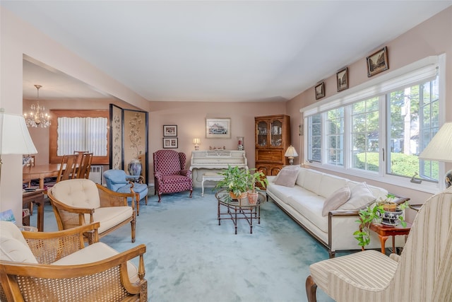 carpeted living room with a chandelier