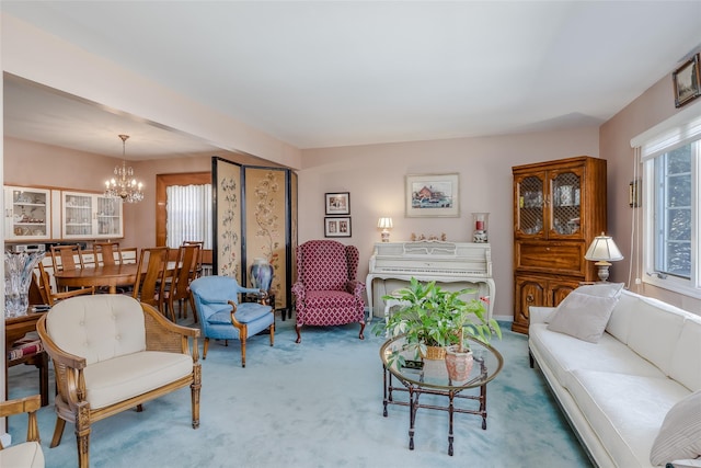 living area featuring carpet flooring and an inviting chandelier