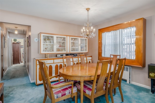 dining space with an inviting chandelier, carpet flooring, and baseboards