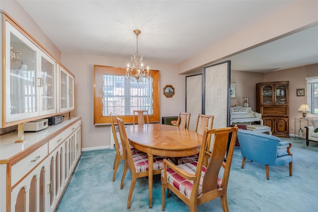 dining room featuring baseboards, light colored carpet, and an inviting chandelier