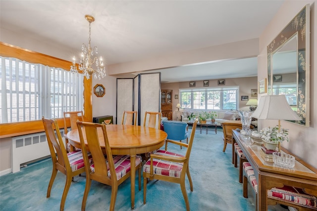 carpeted dining area featuring an inviting chandelier and radiator