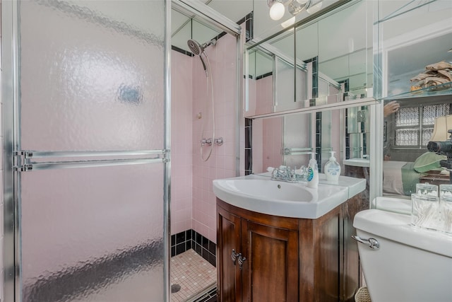 full bathroom with vanity, a stall shower, and toilet