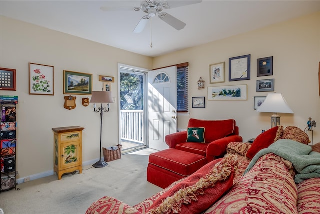 carpeted living room featuring baseboards and a ceiling fan