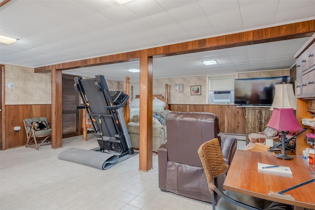 workout area with wainscoting, cooling unit, a baseboard heating unit, and wood walls