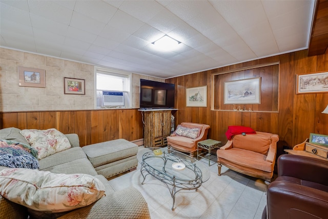 living area with wood walls, a baseboard radiator, and cooling unit