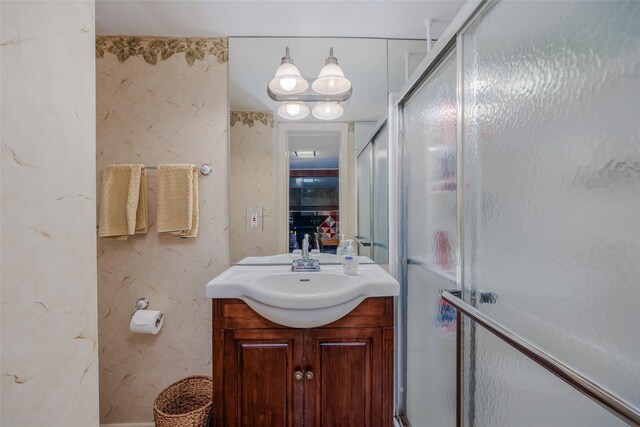 bathroom with vanity and a shower stall