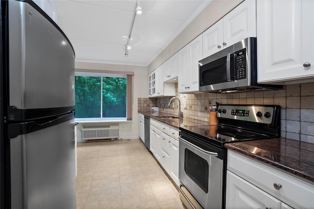 100 High Point Dr Unit 504, Hartsdale, NY 10530 - kitchen featuring stainless steel appliances, a sink, white cabinetry, track lighting, and dark stone countertops