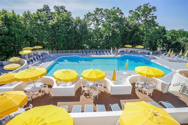 100 High Point Dr Unit 504, Hartsdale, NY 10530 - community pool with fence, a patio area, and view of wooded area