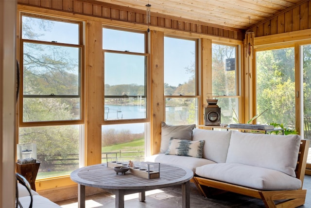 sunroom / solarium featuring a water view, wood ceiling, lofted ceiling, and a wealth of natural light