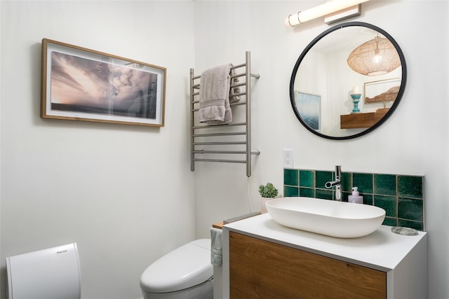 bathroom featuring radiator heating unit, vanity, and toilet