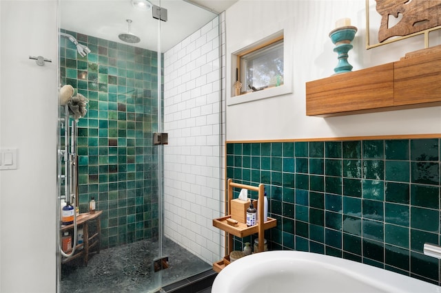 full bathroom with tile walls and a shower stall