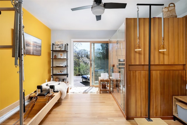 interior space with a ceiling fan and light wood-style flooring