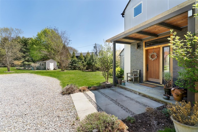 doorway to property with a lawn