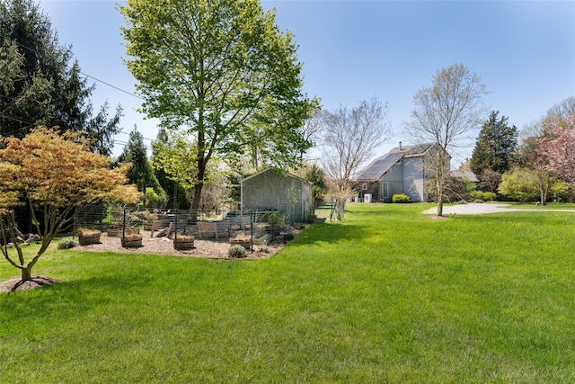 view of yard with fence and an outbuilding