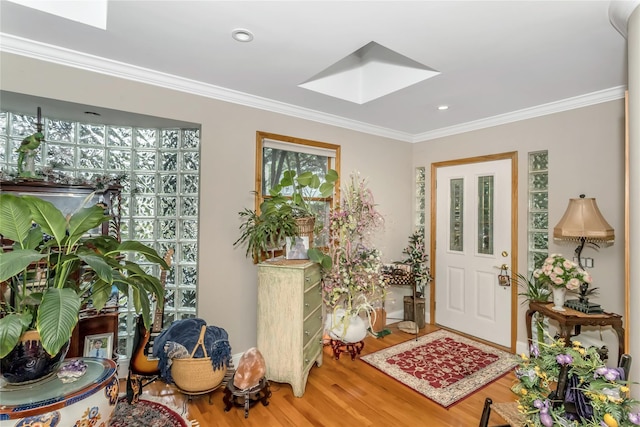 foyer entrance featuring ornamental molding, recessed lighting, a skylight, and wood finished floors