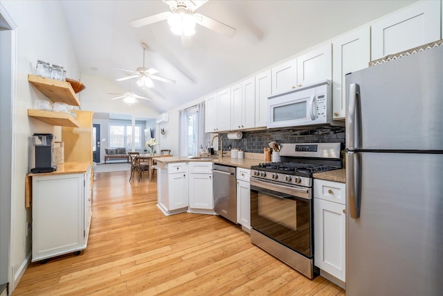 323 New York Ave, Long Beach, NY 11561 - kitchen featuring ceiling fan, appliances with stainless steel finishes, light wood-style floors, a peninsula, and lofted ceiling