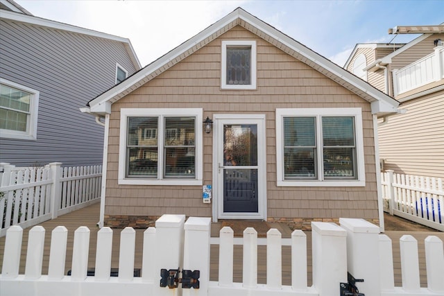 323 New York Ave, Long Beach, NY 11561 - view of front of home featuring fence private yard and stone siding