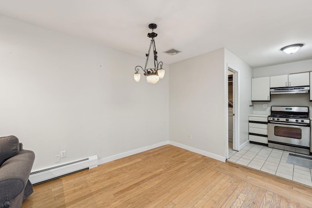 kitchen with stainless steel range with gas stovetop, light wood-type flooring, baseboards, a baseboard heating unit, and under cabinet range hood
