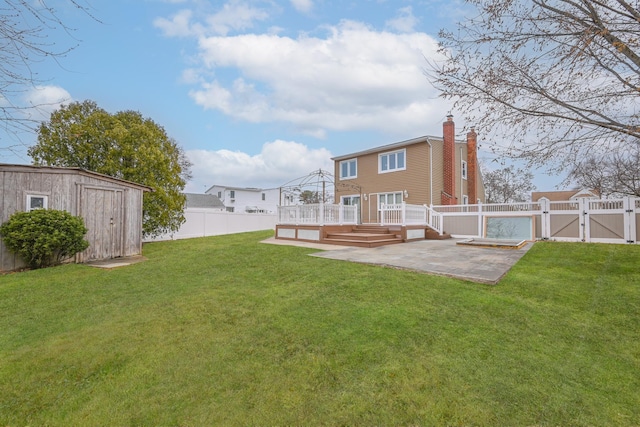 100 Morris Pkwy, Valley Stream, NY 11580 - view of yard featuring a storage shed, a deck, a gate, a fenced backyard, and a patio