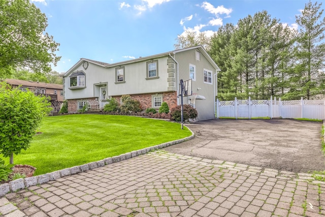 view of front of house featuring asphalt driveway and brick siding
