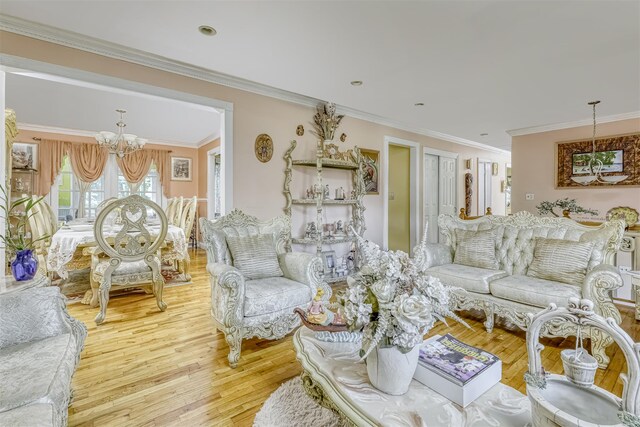 living room with a chandelier, wood finished floors, and ornamental molding