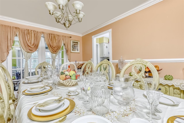 dining room with a chandelier and crown molding