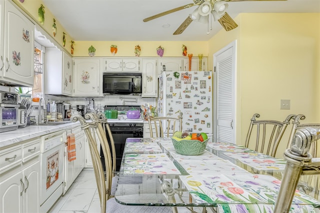 kitchen with black appliances, ceiling fan, white cabinets, light marble finish floors, and light countertops