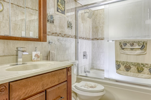 full bath featuring toilet, vanity,  shower combination, and tile walls