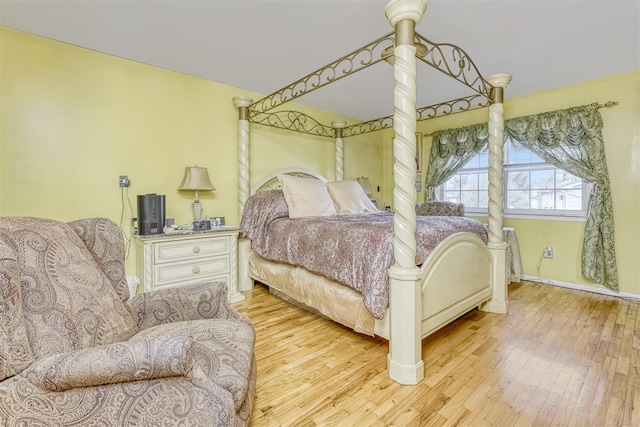 bedroom with wood finished floors and baseboards