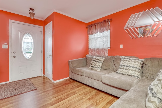 foyer featuring wood finished floors, plenty of natural light, ornamental molding, and baseboards