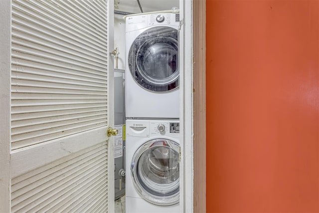 washroom featuring stacked washing machine and dryer