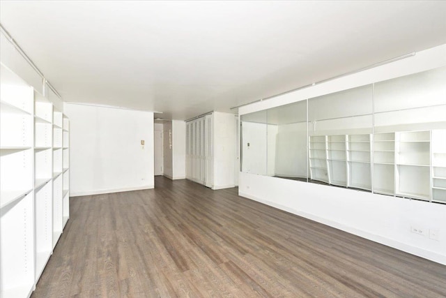 empty room featuring baseboards and wood finished floors