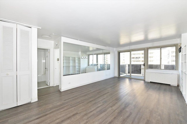 unfurnished sunroom featuring radiator heating unit