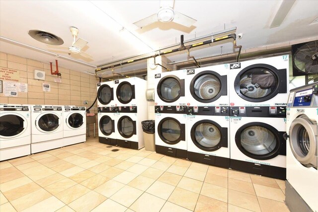 shared laundry area featuring a garage, separate washer and dryer, ceiling fan, and stacked washing maching and dryer