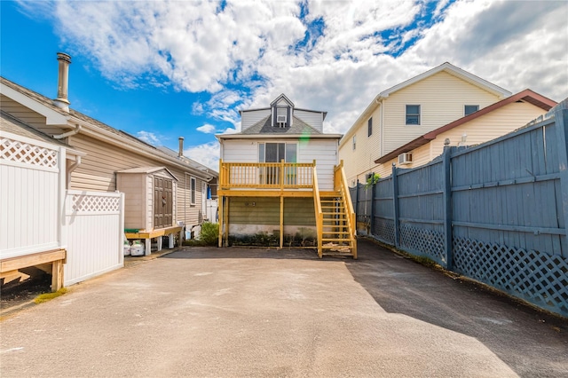 14-11 Cross Bay Blvd, Broad Channel, NY 11693 - back of property with stairway, fence, a shed, and an outdoor structure