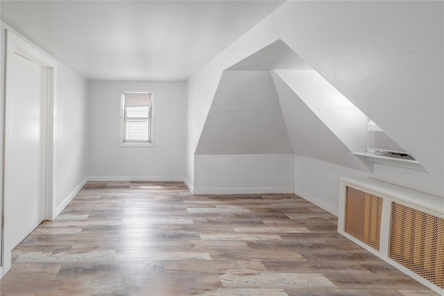 14-11 Cross Bay Blvd, Broad Channel, NY 11693 - bonus room featuring wood finished floors, baseboards, and radiator heating unit