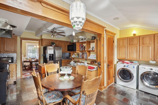 dining area with stone tile flooring, ornamental molding, ceiling fan, washer and clothes dryer, and vaulted ceiling