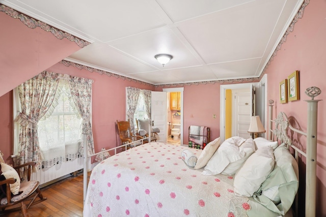 bedroom featuring connected bathroom, coffered ceiling, and hardwood / wood-style floors