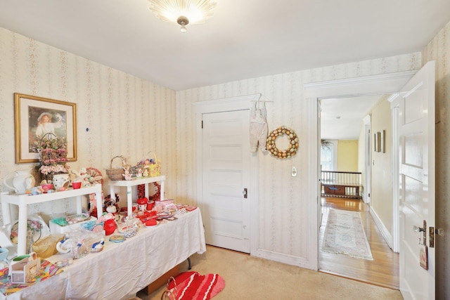 carpeted bedroom with wallpapered walls