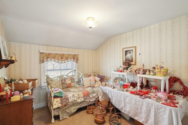 carpeted bedroom featuring wallpapered walls and lofted ceiling