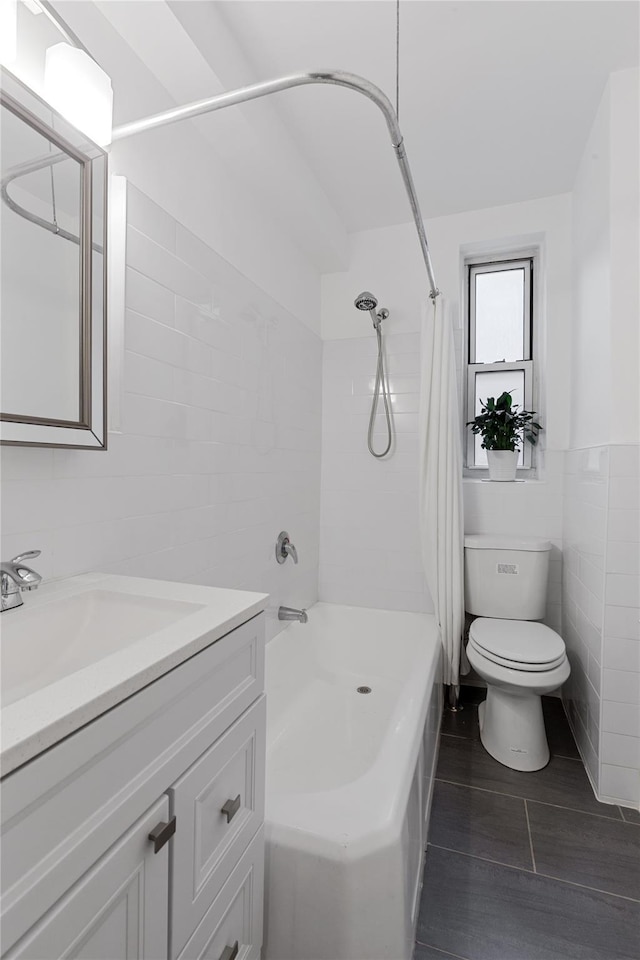 full bath featuring vanity, wood finished floors, shower / bath combination with curtain, toilet, and tile walls