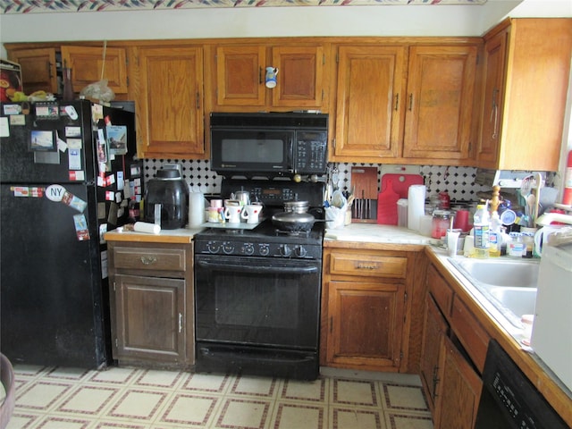 kitchen featuring black appliances, light countertops, light floors, and brown cabinets