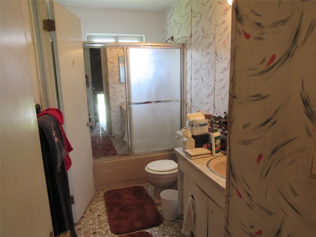 full bathroom with toilet, vanity, and combined bath / shower with glass door