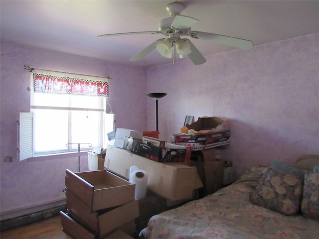bedroom featuring wood finished floors and ceiling fan